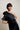 HÉLISSE - Top asymétrique en satin avec fleur amovible noir
